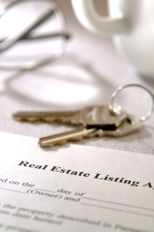 a real estate listing agreement with two keys laying on it next to a cup of coffee and eyeglasses