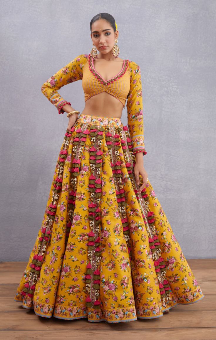 Editor's Note Featuring Yellow Sunehra Tasneem Lehenga Set Color: Yellow Fabric: Pure Cotton Silk, Handwoven Chanderi, Organza Silk Component: Lehenga, blouse and dupatta Occasion: Haldi mehndi Care: Dry Clean Only About the Designer Torani by Karan Torani stands handcrafted luxury inspired by the myriad tales of Indian mythology. Torani is a potpourri of all things nostalgic that binds you with a memory long forgotten. The label works with and revives timeless Indian textiles and embroidery tra Cotton Lehenga Blouse Designs, Yellow Navratri Outfit, Torani Lehenga, Cotton Lehenga Designs, Orang India, Haldi Dress, Indian Mythology, Haldi Outfits, Haldi Outfit