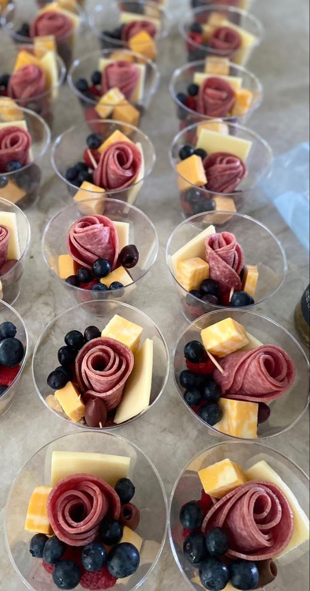 many small cups filled with different types of food on top of a table next to blueberries and cheese