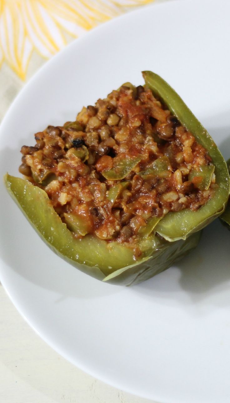 two stuffed peppers on a white plate