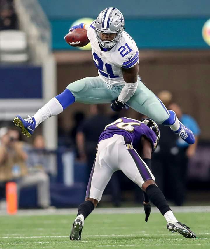 two football players are jumping in the air