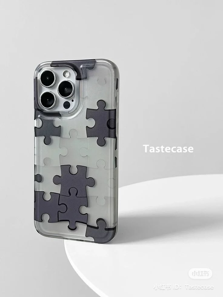 an iphone case made out of puzzle pieces with the text tastecase printed on it