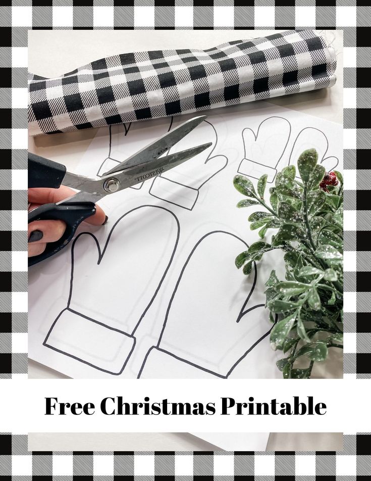 a person cutting out paper with scissors on top of it and the words free christmas printable