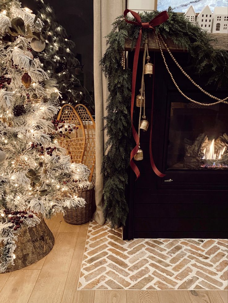 a decorated christmas tree in front of a fireplace