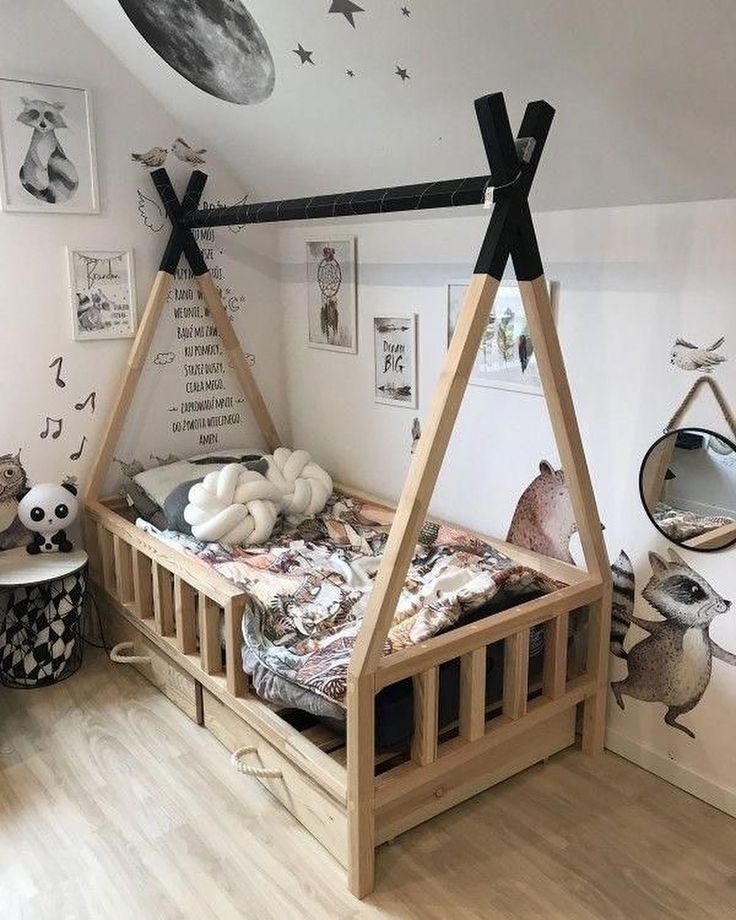 a child's bedroom with a teepee tent bed