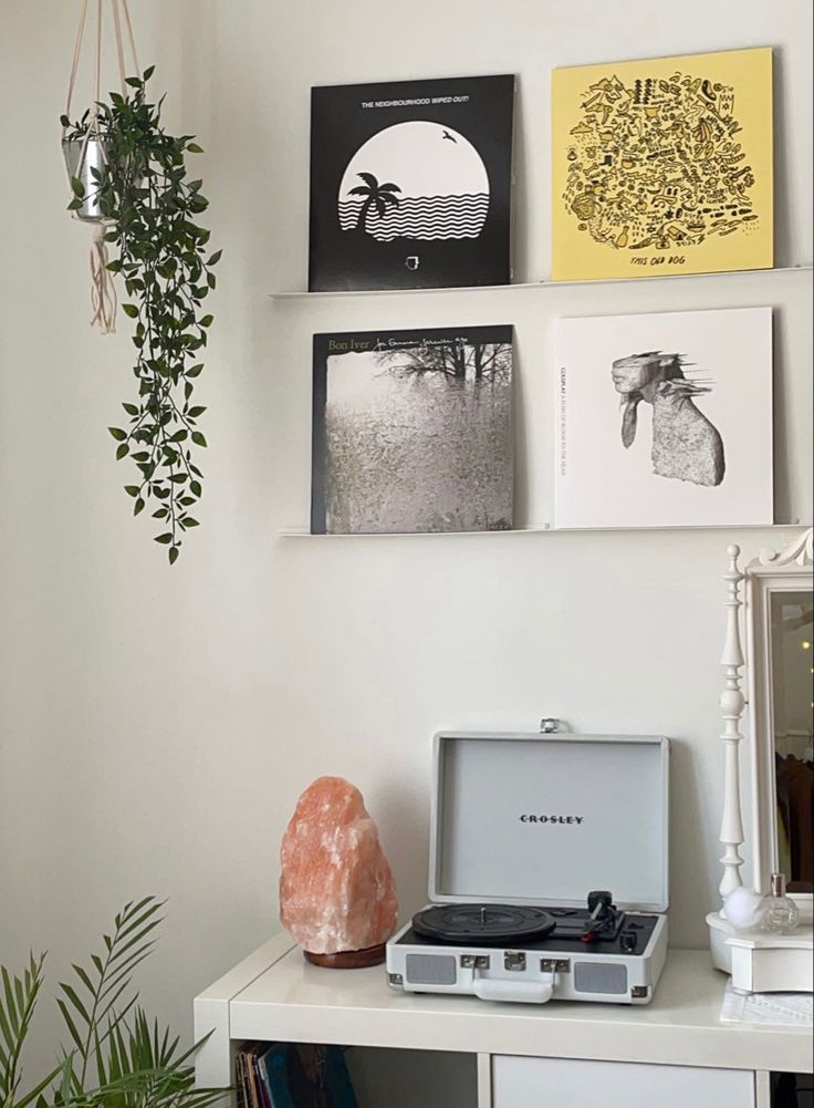 a white table topped with pictures and a record player