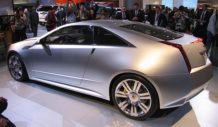 a silver car is on display at an auto show