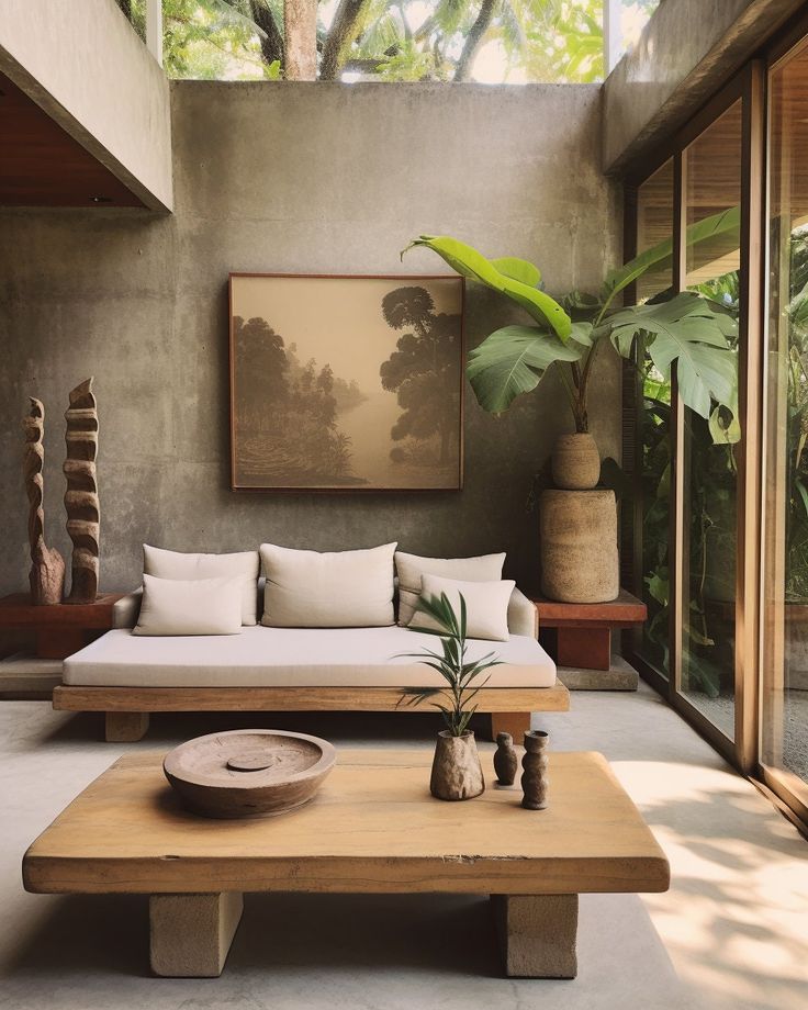 a living room filled with lots of furniture next to a plant on top of a wooden table