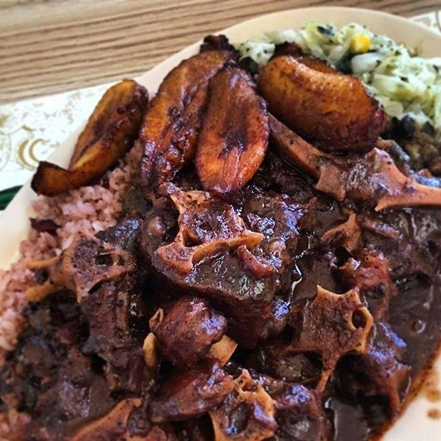 a white plate topped with meat and potatoes