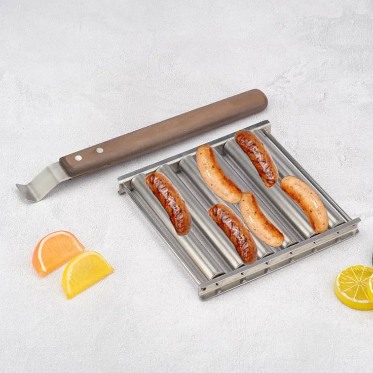 hotdogs and lemon slices on a grill with a knife