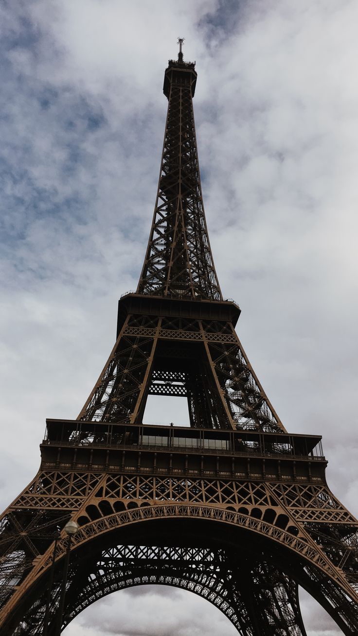 the eiffel tower is very tall and has a clock on it's side