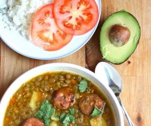 two bowls filled with food next to an avocado on a wooden table top