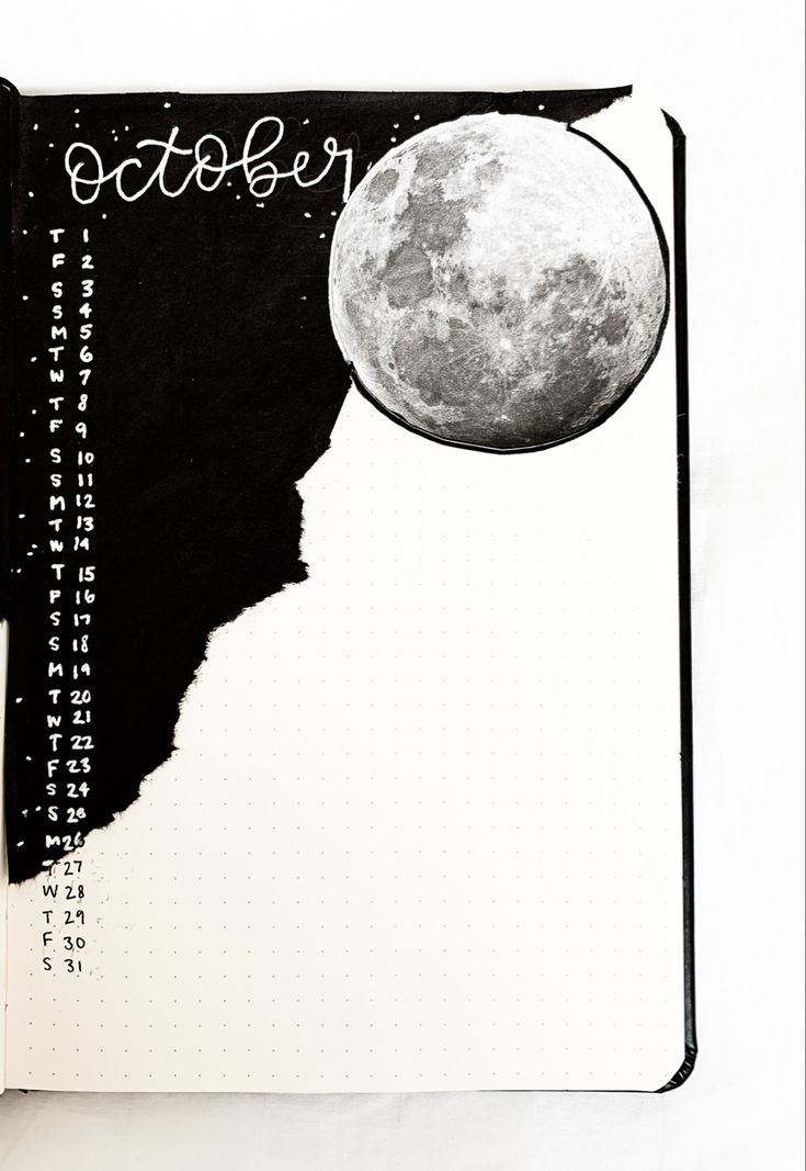 an open notebook with a drawing of the moon