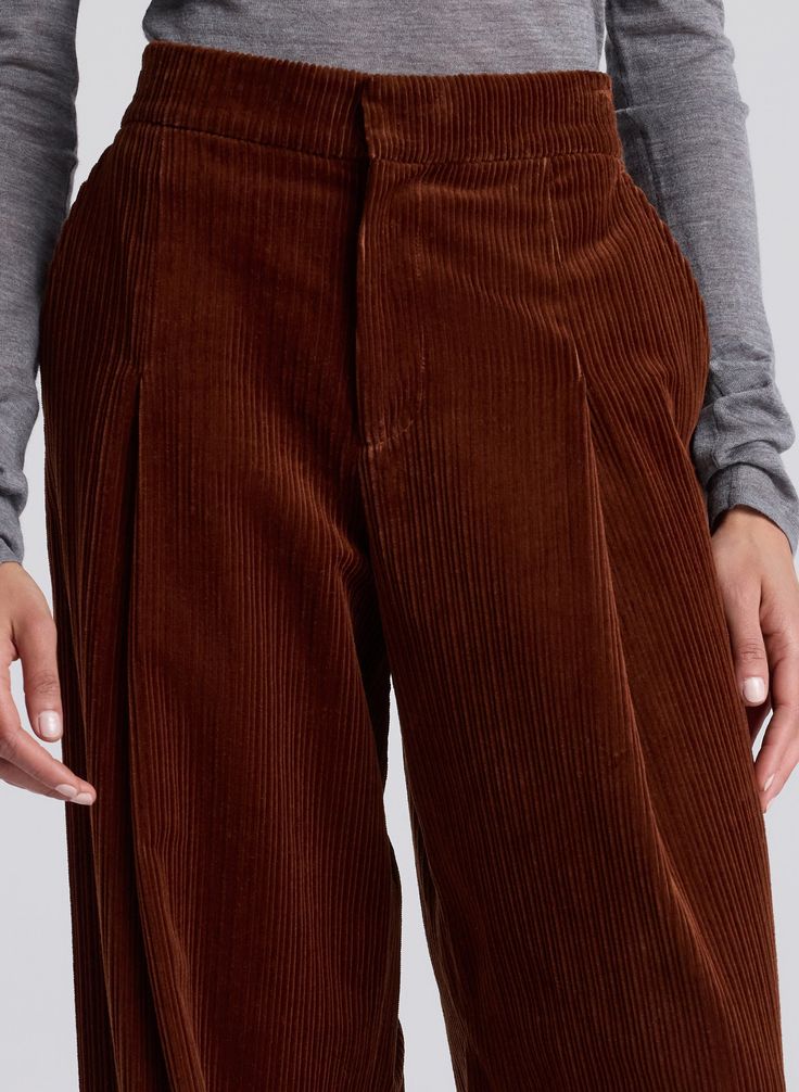 The Andrew Pant is crafted from variegated velvet corduroy in a brandy hue. This mid-rise silhouette offers a relaxed fit through the hips with front pleating, back pockets and a full-length hem. This style runs true to size. Shop Bottoms. Styling Tip: Contrast the voluminous leg with a slim-fit top tucked into the waistline. Brown Straight Leg Corduroy Bottoms, Fitted Full-length Corduroy Pants, Straight-leg Corduroy Pants With Hip Pockets, Fitted Corduroy Full-length Pants, Mid-rise Brown Corduroy Pants, Designer Bottoms, Raw Denim Jeans, Corduroy Pant, Strapless Jumpsuit