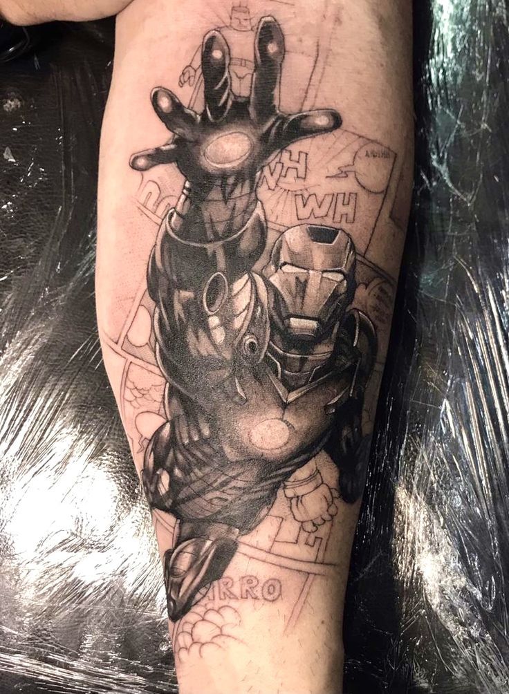 a man's leg with a black and white tattoo design on it, which has an image of iron man