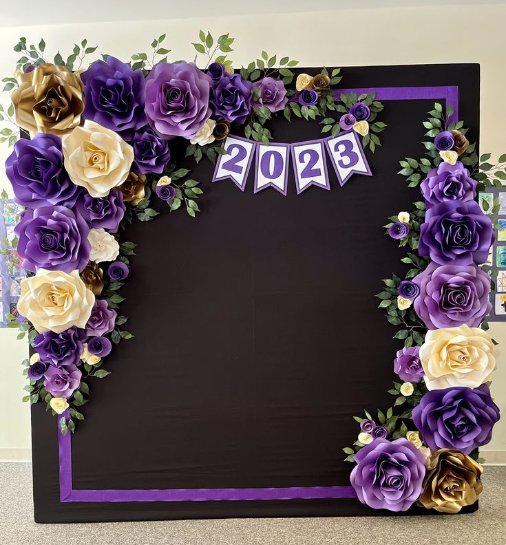 a purple and white photo frame with flowers on the front, banner in the middle