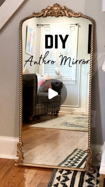 a large mirror sitting on top of a wooden floor