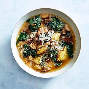 a white bowl filled with soup and vegetables