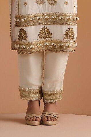 Ivory kurta with sequins, dabka, nakshi and zari hand embroidery. Paired with a matching plain pant with embroidered hemline and an embroidered dupatta. - Aza Fashions Elegant Bottoms With Mirror Work For Festive Occasions, Designer Wear Pants With Mirror Work For Eid, Bollywood Style Festive Bottoms With Mirror Work, Festive Bollywood Bottoms With Mirror Work, Elegant Festive Bottoms With Mirror Work, Traditional Pants With Mirror Work For Eid, Elegant White Festive Pants, Festive Mirror Work Bottoms For Eid, Elegant White Pants With Resham Embroidery