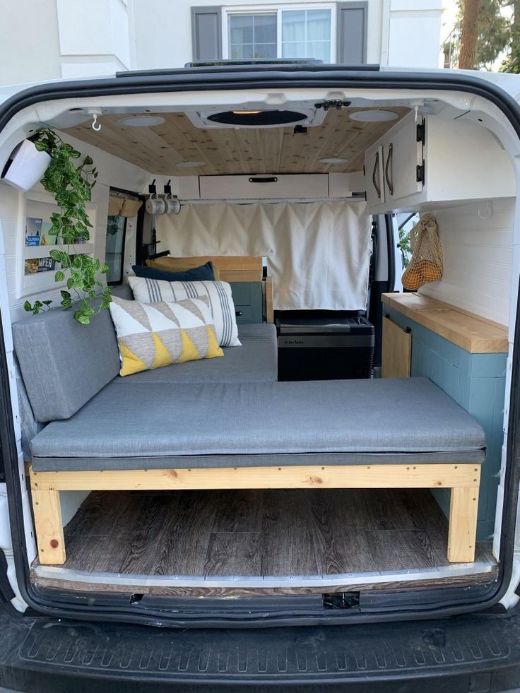 the interior of a camper van that has been converted into a bed