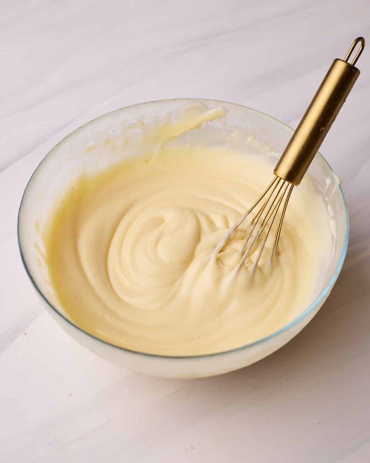 a whisk in a bowl filled with batter