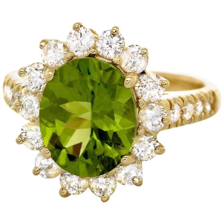 an oval green and white diamond ring on a gold band with two rows of diamonds around it