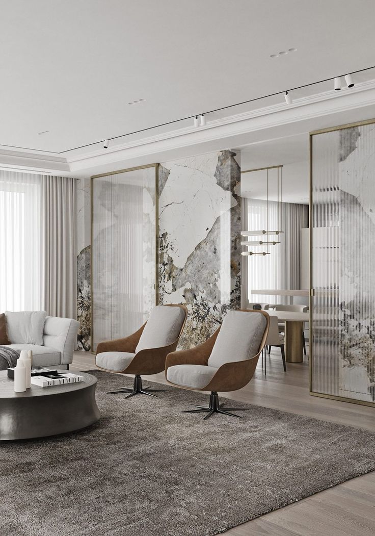 the living room is decorated in white and grey tones with marble accents on the walls