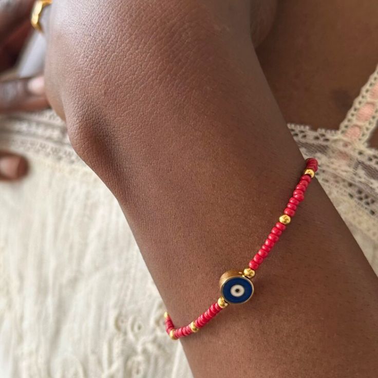 Add some charm and whimsy to your bracelet stack with our Beaded Evil Eye Bracelet! Perfect for summertime and adventures abroad, it's the cutest and most fun accessory around. Keep the good vibes coming with this playful addition. Materials: Premium Coloured Beads 18K Gold Plated over Stainless Steel - Tarnish Free Measurements: 6.5" Long + 2" Extender 3mm wide beads + 7mm wide Evil Eye Playful Adjustable Beaded Bracelets For Vacation, Adjustable Playful Beaded Bracelets For Vacation, Playful Colorful Beaded Bracelets For Vacation, Bohemian Red Beaded Bracelets For Vacation, Casual Evil Eye Bracelet With Colorful Beads As Gift, Playful Round Beads Bracelets For Vacation, Playful Beaded Bracelets With Letter Beads For Vacation, Playful Round Beaded Bracelets For Vacation, Spiritual Beaded Bracelets With Round Beads For Vacation