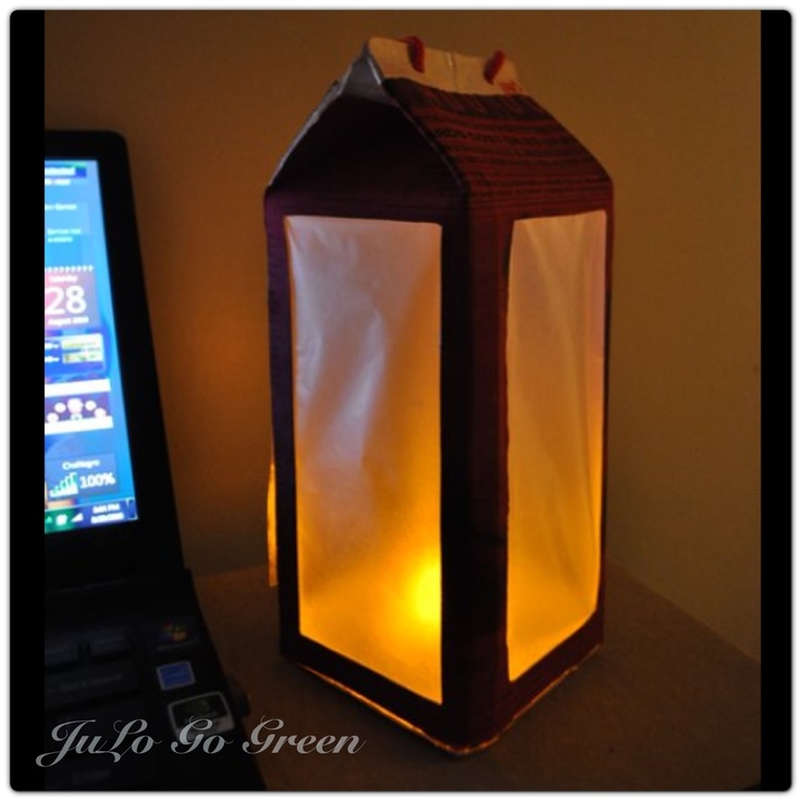 a lit up lantern sitting next to a cell phone