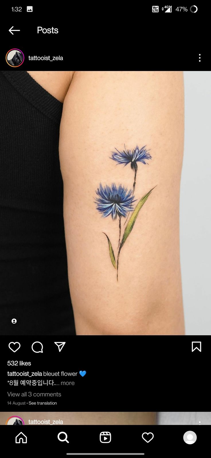 a blue flower tattoo on the left thigh