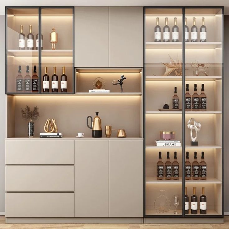 a room with shelves filled with bottles and glasses on top of wooden flooring next to a white wall