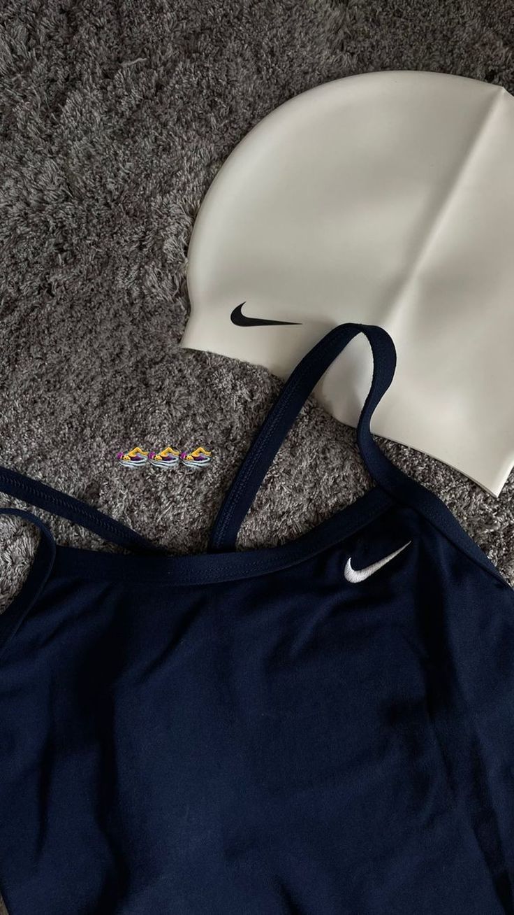 the nike bra is laying on the floor next to it's headbands