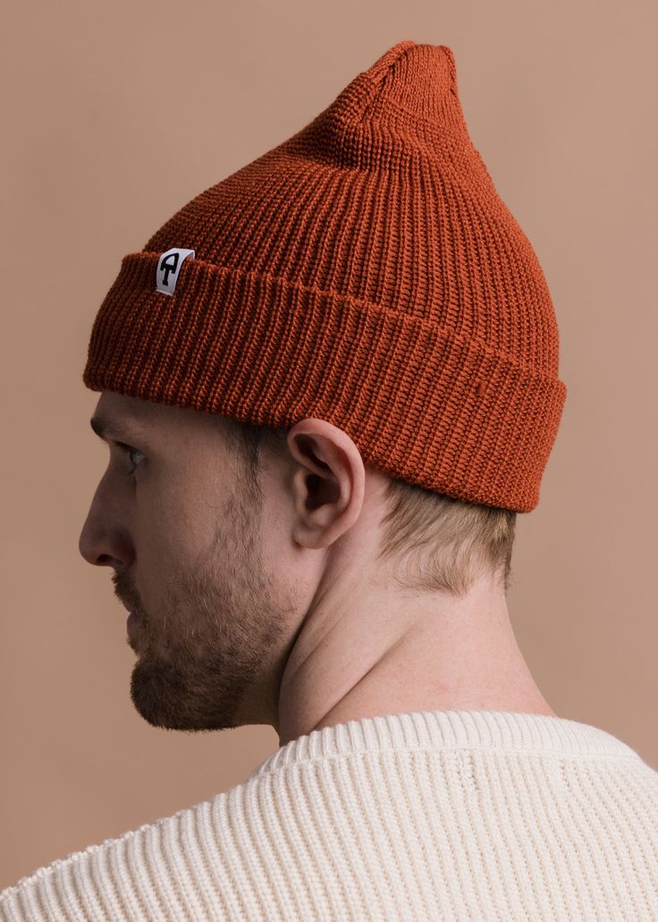 An American Trench staple product, the Merino Cardigan Stitch Beanie comes in five colors. Constructed from a classic cardigan stitch, these beanies have the shape necessary to wear either above or below the ears. Merino Wool regulates temperature far better than acrylics - which means this beanie will perform in rain, shine, or snow. Available for FW22 in Indigo, Black, Navy, Olive, Coyote, Pine & Rust Classic Cardigan, Merino Wool, Winter Hats, Rust, Wool, Navy, How To Wear, Black, Color