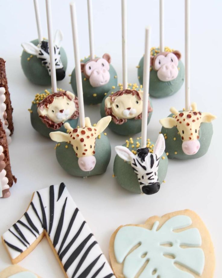 there are many decorated cookies with zebras and giraffes on them next to each other