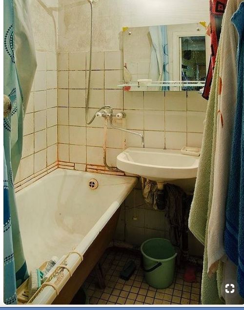 a bath tub sitting next to a sink in a bathroom