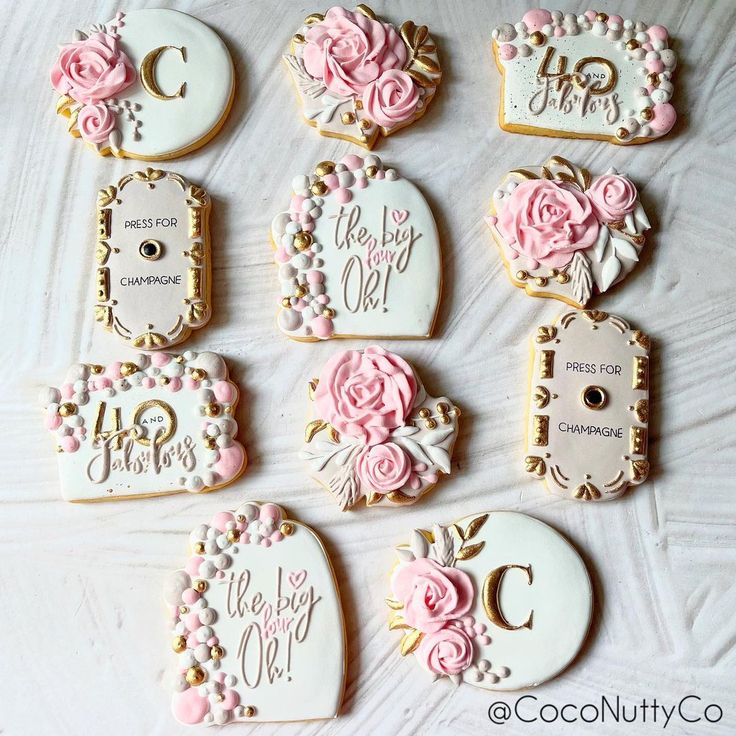 decorated cookies are arranged in the shape of hearts and flowers, with names on them