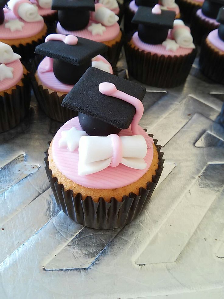 cupcakes decorated with black and pink frosting