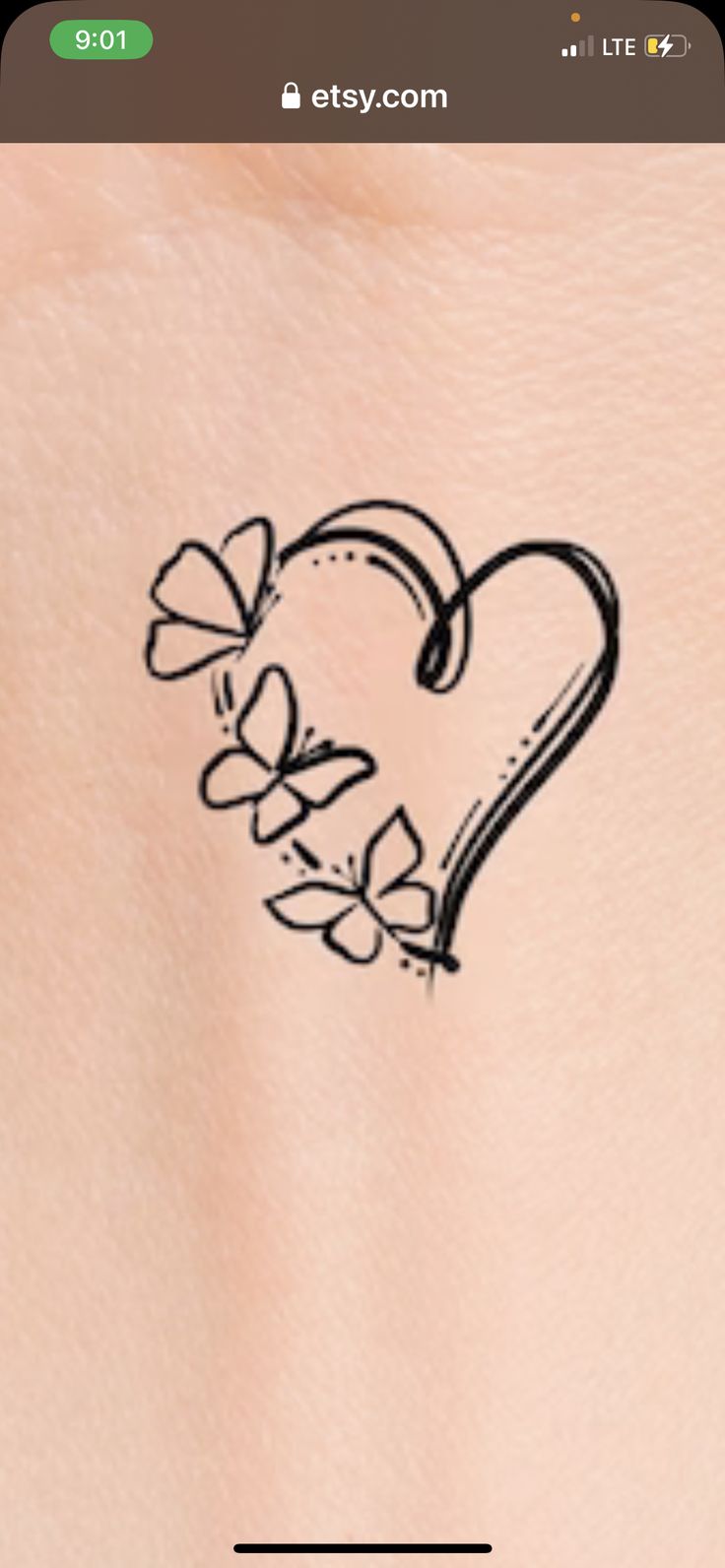 the back of a woman's stomach with a heart tattoo on it