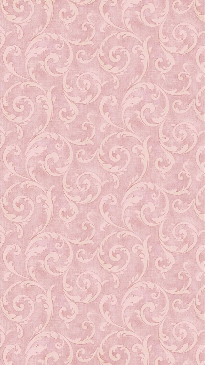 a pink wallpaper with white swirls on the top and bottom half of it