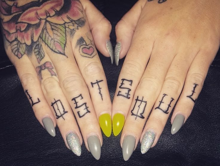 two hands with different designs on them, one has yellow nails and the other has grey fingernails