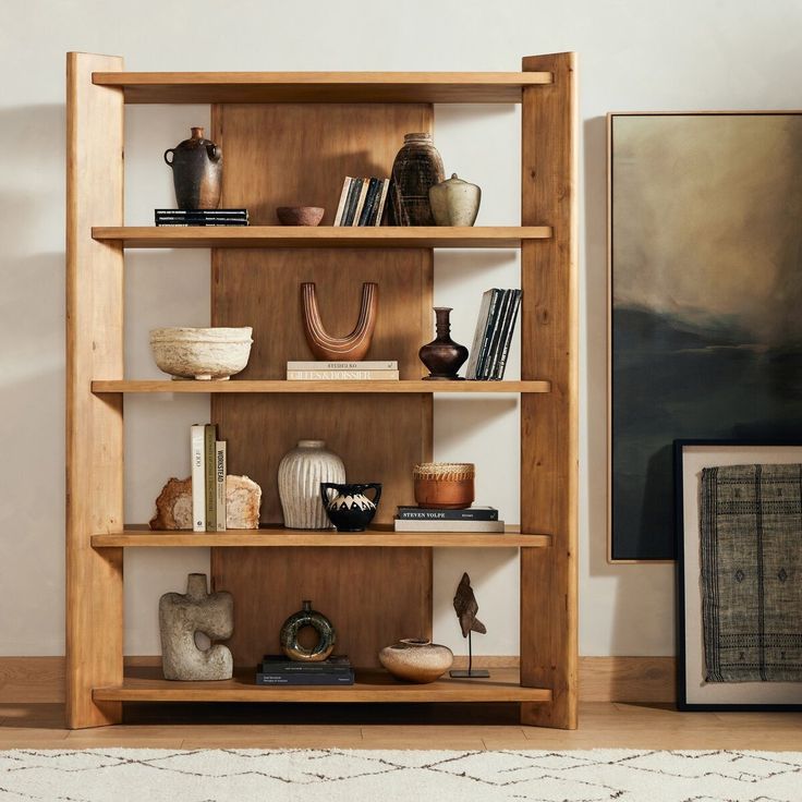 a bookshelf filled with lots of different types of items on top of it