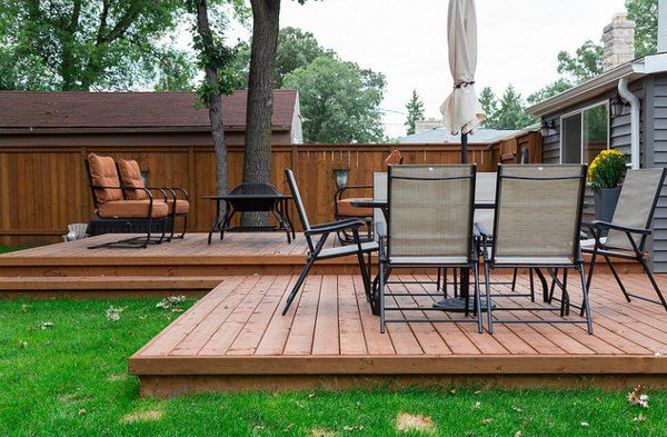 a deck with chairs and an umbrella on it