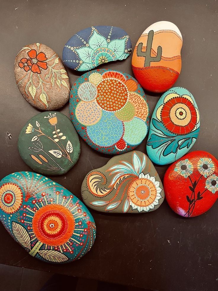 several painted rocks sitting on top of a table