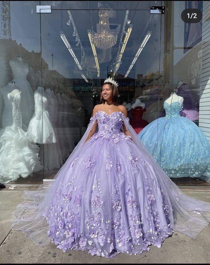 Welcome to Couture Candy's exclusive collection of purple Quinceañera gowns for the 2024 season. Our selection of dresses is expertly made to make every young woman feel exceptional on her milestone day. Our selection includes everything, whether you're searching for something traditional with intricate needlework or something more contemporary with streamlined, clean lines. Purple Sparkly Quince Dress, Light Purple Xv Dresses, Quince Purple Dresses, Purple Dress Quince, Purple Quince Dress With Butterflies, Purple Dresses Quinceanera, 15 Dresses Quinceanera Purple, Lavender Quince Dress, Lavender Sweet 16 Dresses