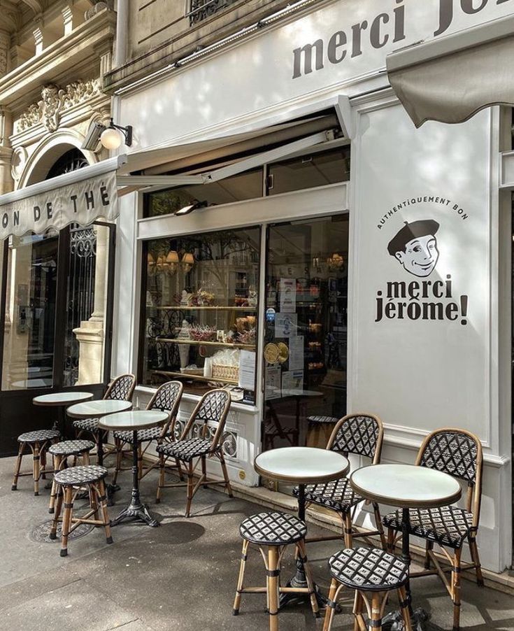 the outside of a restaurant with tables and chairs