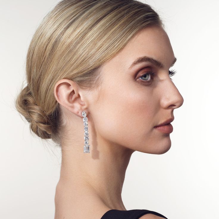 The artistry of these earrings strikes the perfect balance between simplicity and opulence. Each earring boasts a linear design that showcases a combination of round, oval, cushion, and emerald-cut diamonds arranged vertically. At the end of each glittering array is a larger emerald-cut diamond for an absolutely eye-catching finish. Luxury Long Drop Linear Earrings For Formal Occasions, Modern Elegant Earrings For Evening, Elegant Earrings With Timeless Design, Elegant Baguette Cut Diamond Earrings For Formal Occasions, Modern Linear Drop Earrings For Formal Occasions, Elegant Baguette Cut Diamond Earrings, Luxury Linear Earrings With Prong Setting For Formal Events, Luxury Linear Earrings With Prong Setting For Formal Occasions, Fine Jewelry Linear Dangle Earrings For Formal Occasions