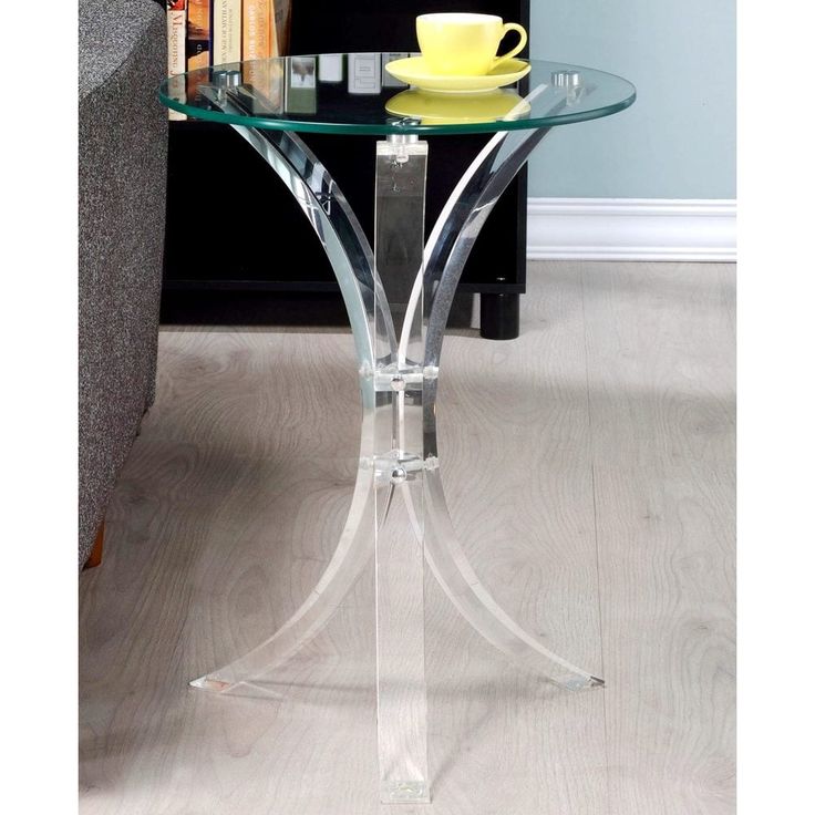 a glass table with a yellow cup on it and some books in front of it