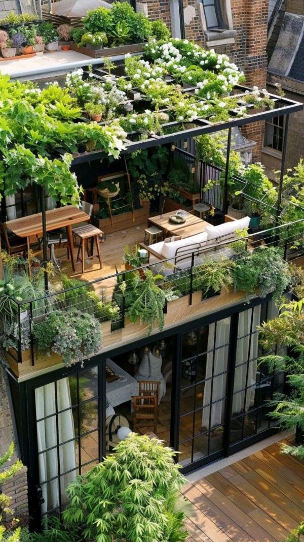 an aerial view of a house with many plants growing on the roof and balcony area