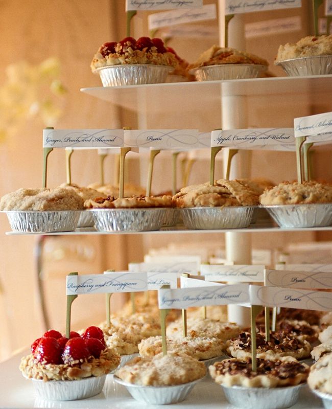 three tiered trays filled with different types of pastries and desserts on top of each other