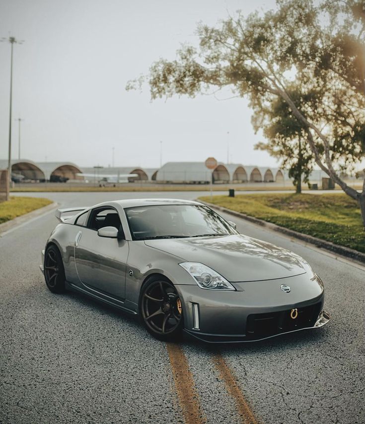 a silver sports car is parked on the street